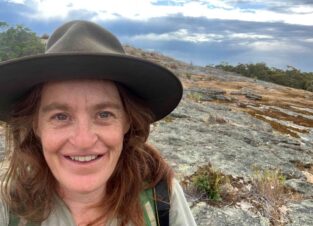 Senior Field Ecologist and Project Manager at Wildlife Unlimited, Hayley Ricardo, out in the field on a large rocky escarpment